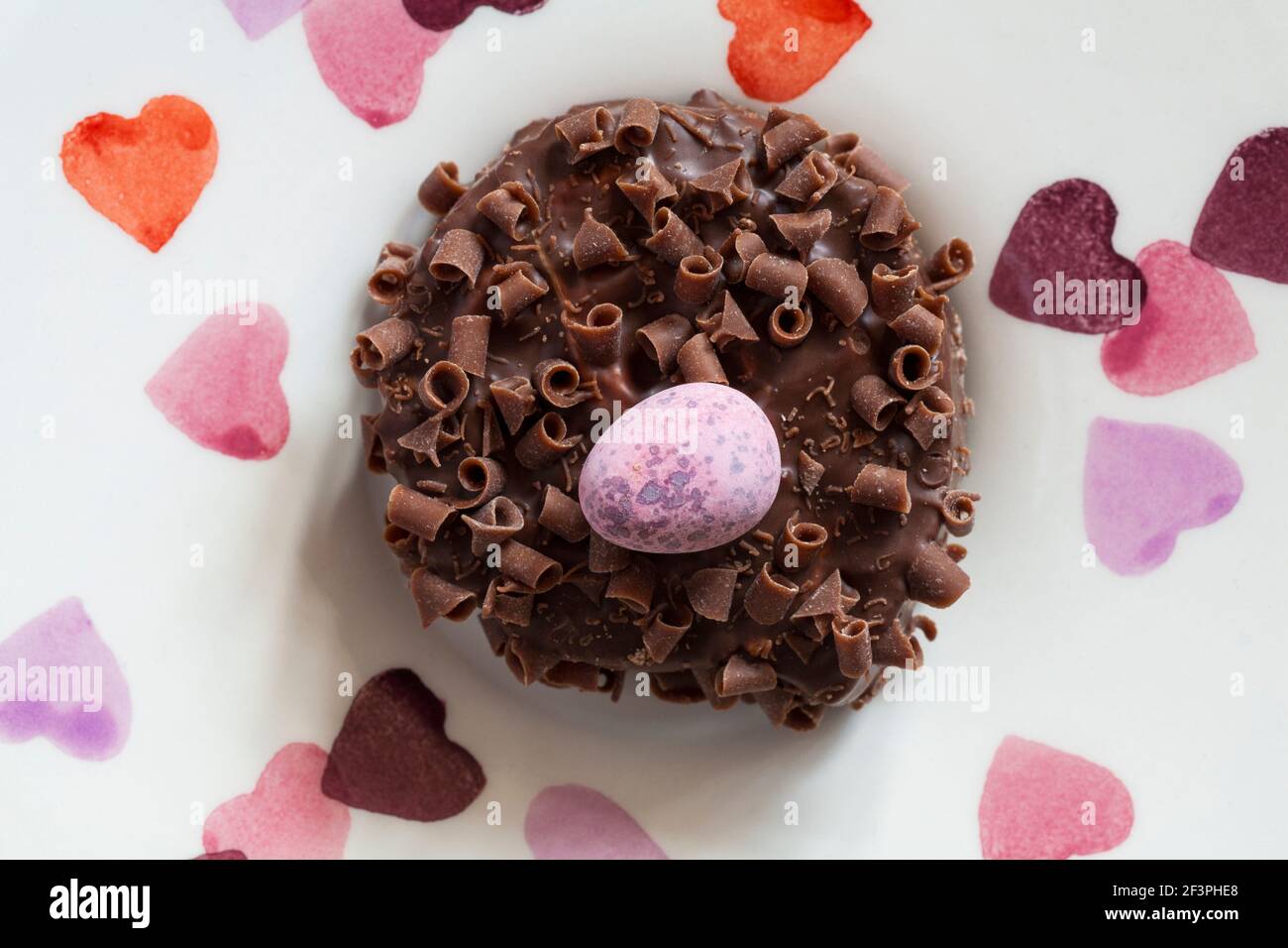 Cadbury Mini Eggs Nest Cake set on plate with hearts on Stock Photo