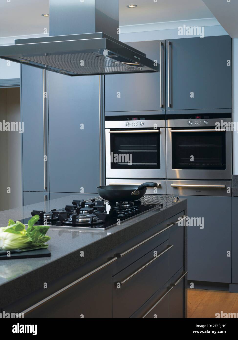 Hob set in central island breakfast bar in contemporary kitchen Stock Photo