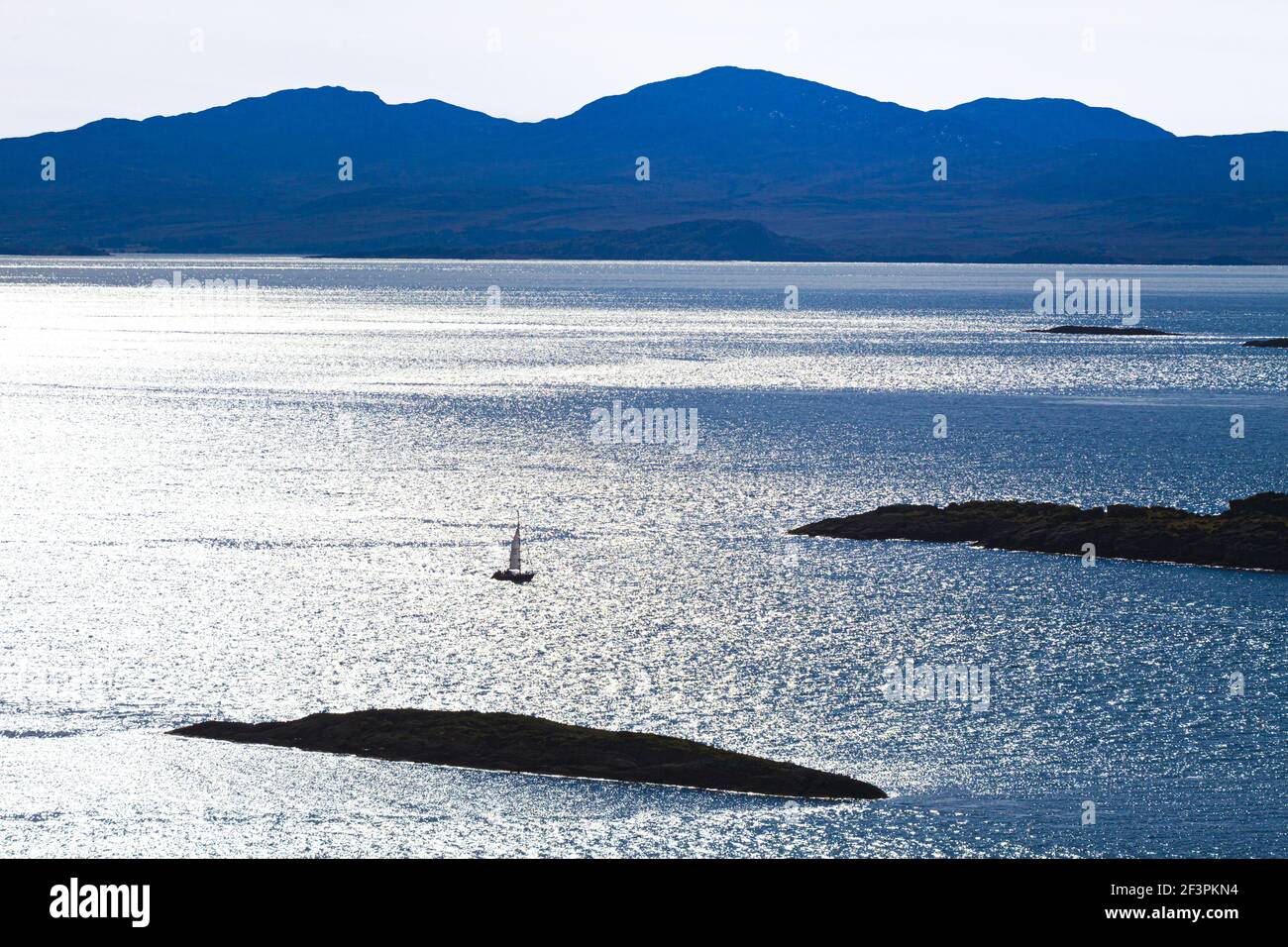 A yacht in the Sound of Jura about to enter Loch Sween viewed from the Knapdale Peninsula north of Kilmory, Argyll & Bute, Scotland UK - Stock Photo