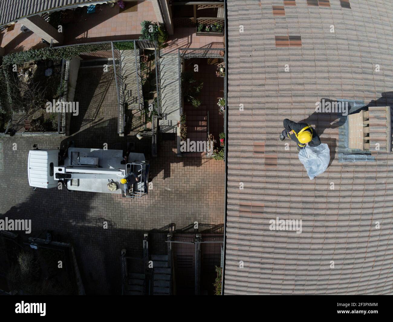 Roof inspection job with platform and worker working on the roof Stock