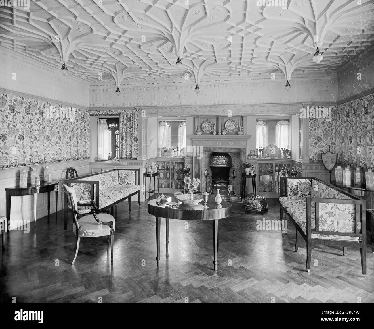 Bidston Court, Birkenhead. Victorian interior of the drawing room looking towards the windows and fireplace. Bidston Court was built in 1891 by the Li Stock Photo