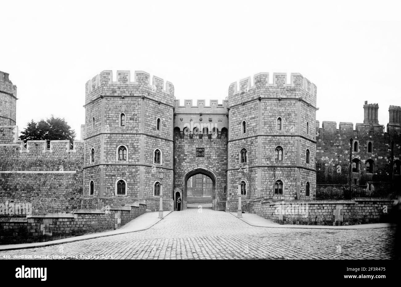 Windsor Castle, Berkshire. Henry VIII Gate.  View taken from castle hill with a guard and sentry box to the left of the gate. Photograph by York and S Stock Photo