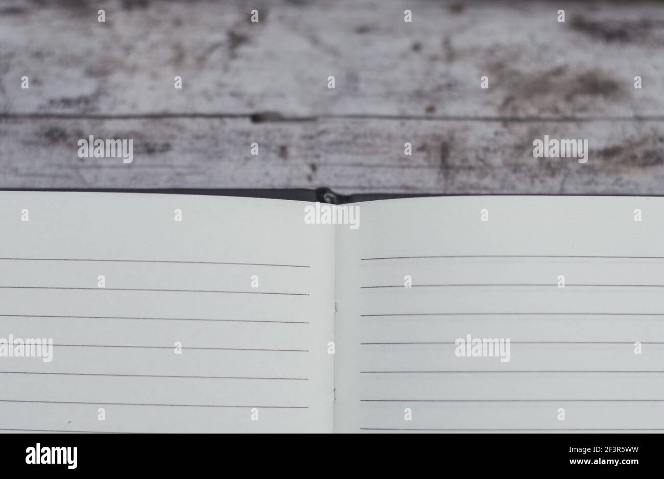 Open book with blank pages on a wooden surface Stock Photo