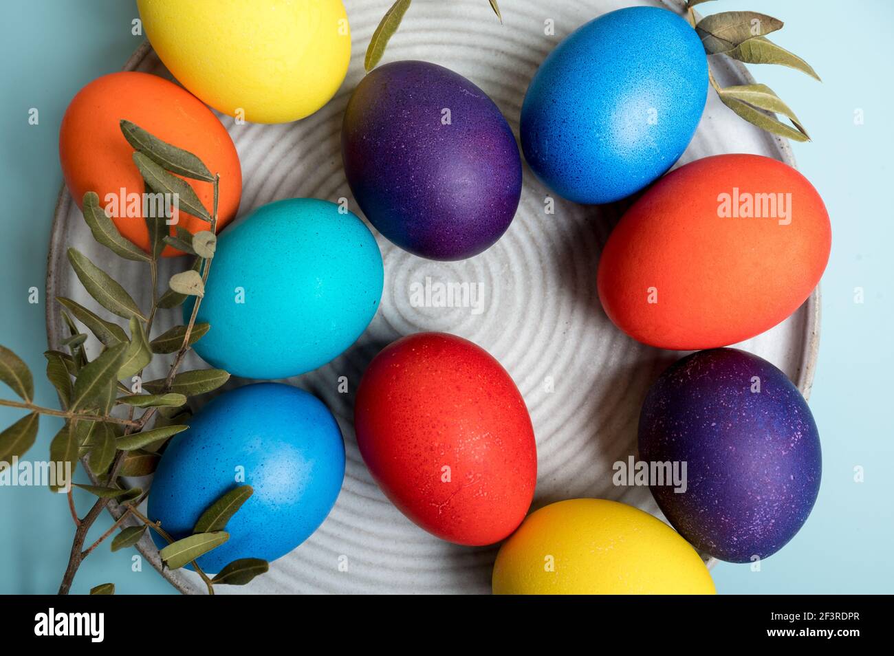 Multi-colored eggs on a blue. Easter holiday background Stock Photo
