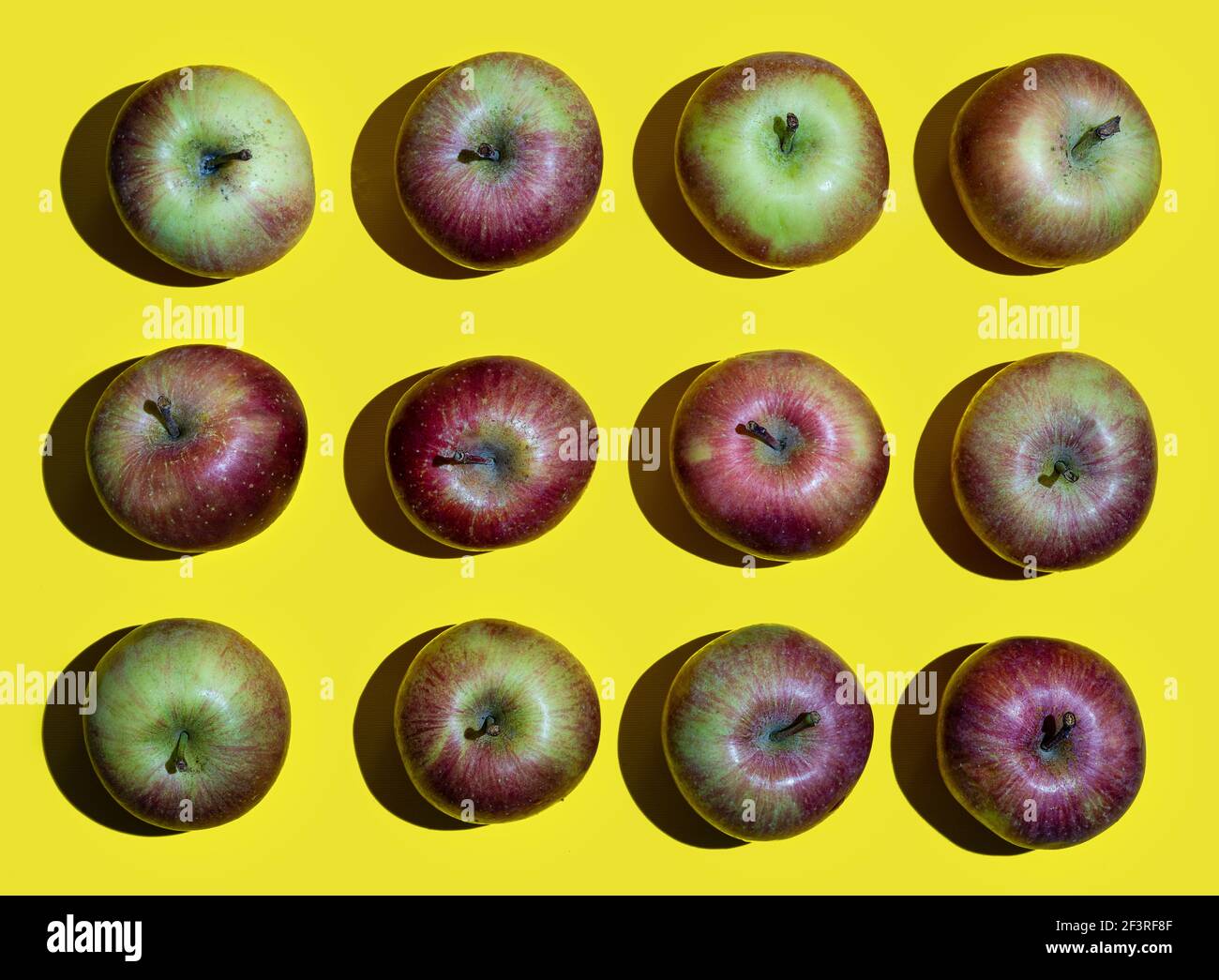 some apple fruits arranged on a yellow surface Stock Photo Alamy
