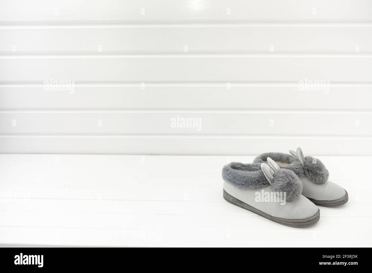 Beautiful fur slippers in the form on a white background, concept of comfort in the house Stock Photo