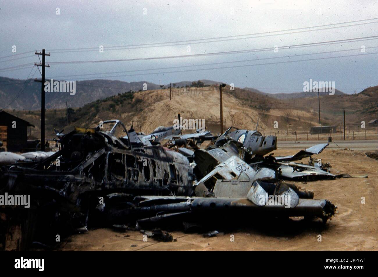 The charred remains of a North American F051 Mustang in the 'bone yard'. The parts of other F-51 Mustangs and Mk. IVs appear. Serial numbers KM326 and KM370 are visible on scraps from South African Air Force aircraft. Stock Photo