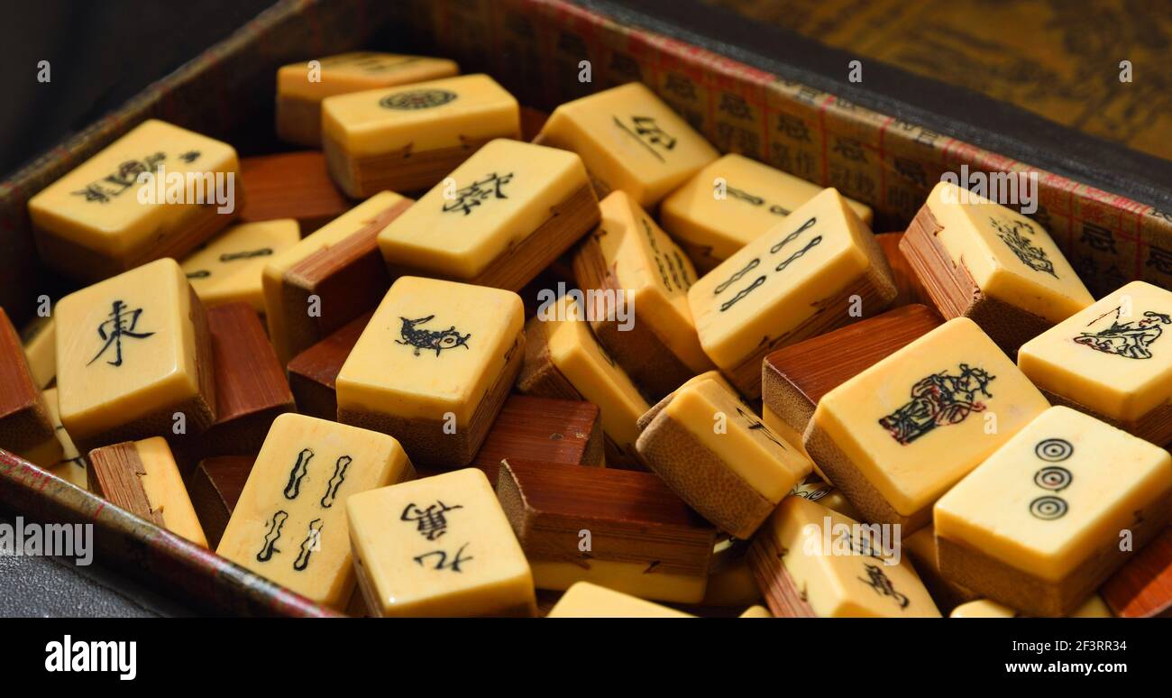 Vintage Bone and bamboo  Mahjong or mah-jongg playing tiles in box. Close up Background. Stock Photo