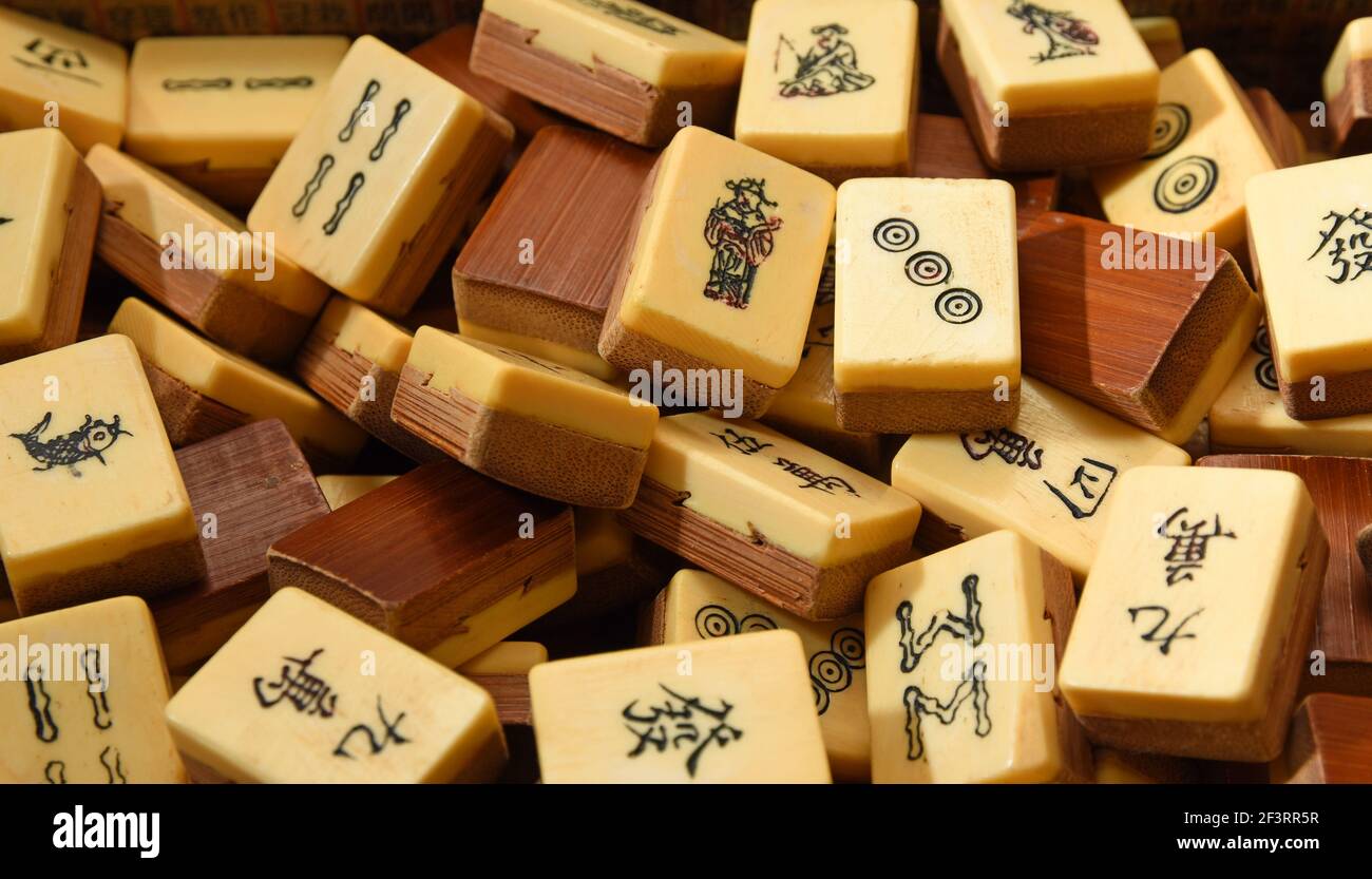 Vintage Bone and bamboo  Mahjong or mah-jongg playing tiles in box. Close up Background. Stock Photo