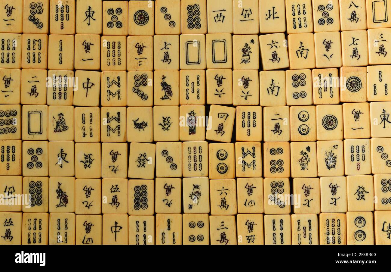 Vintage Bone and bamboo  Mahjong or mah-jongg playing tiles in box. Background. Stock Photo