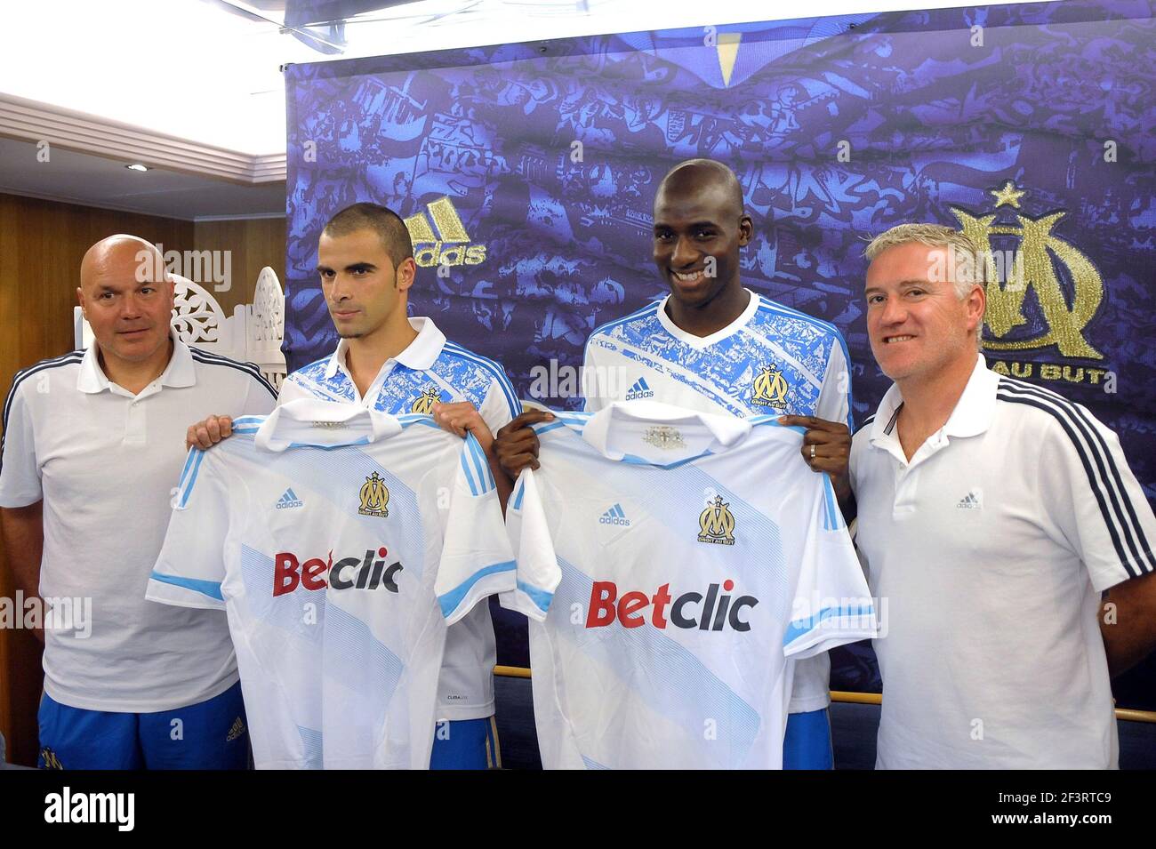 FOOTBALL - MISCS - FRENCH CHAMPIONSHIP 2011/2012 - LIGUE 1 -OLYMPIQUE MARSEILLE - 6/07/2011 - PHOTO PASCAL ALLEE / DPPI - PRESENTATION MARSEILLE'S NEWS PLAYERS GENNARO BRACIGLIANO AND ALOU DIARRA WITH JOSE ANIGO SPORTS DIRECTOR AT LEFT AND DIDIER DESCHAMP THE HEAD COACH AT RIGHT Stock Photo