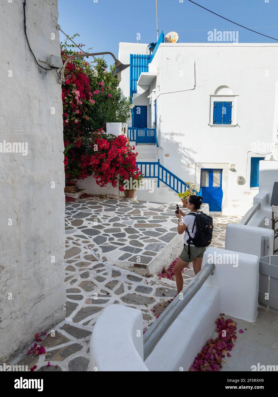 Parikia, Paros Island, Greece - 26 September 2020: A woman with a camera  exploring the old town of Parikia. Traditional, withe architecture and a  ston Stock Photo - Alamy