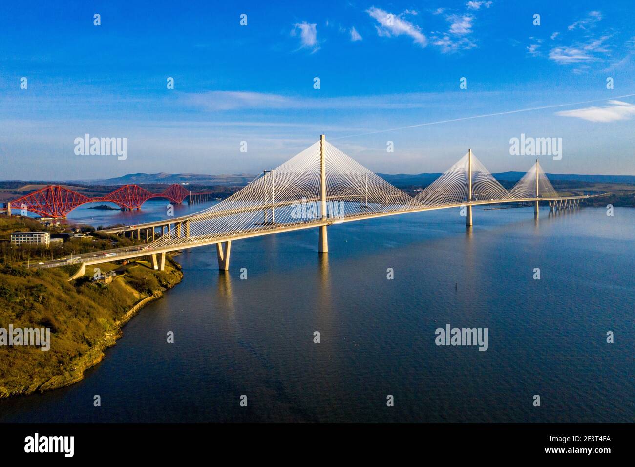 Aerial view from Rosyth showing three bridges spanning the Firth of Forth. The Queensferry Crossing, Forth Road Bridge and Forth Rail Bridge. Stock Photo