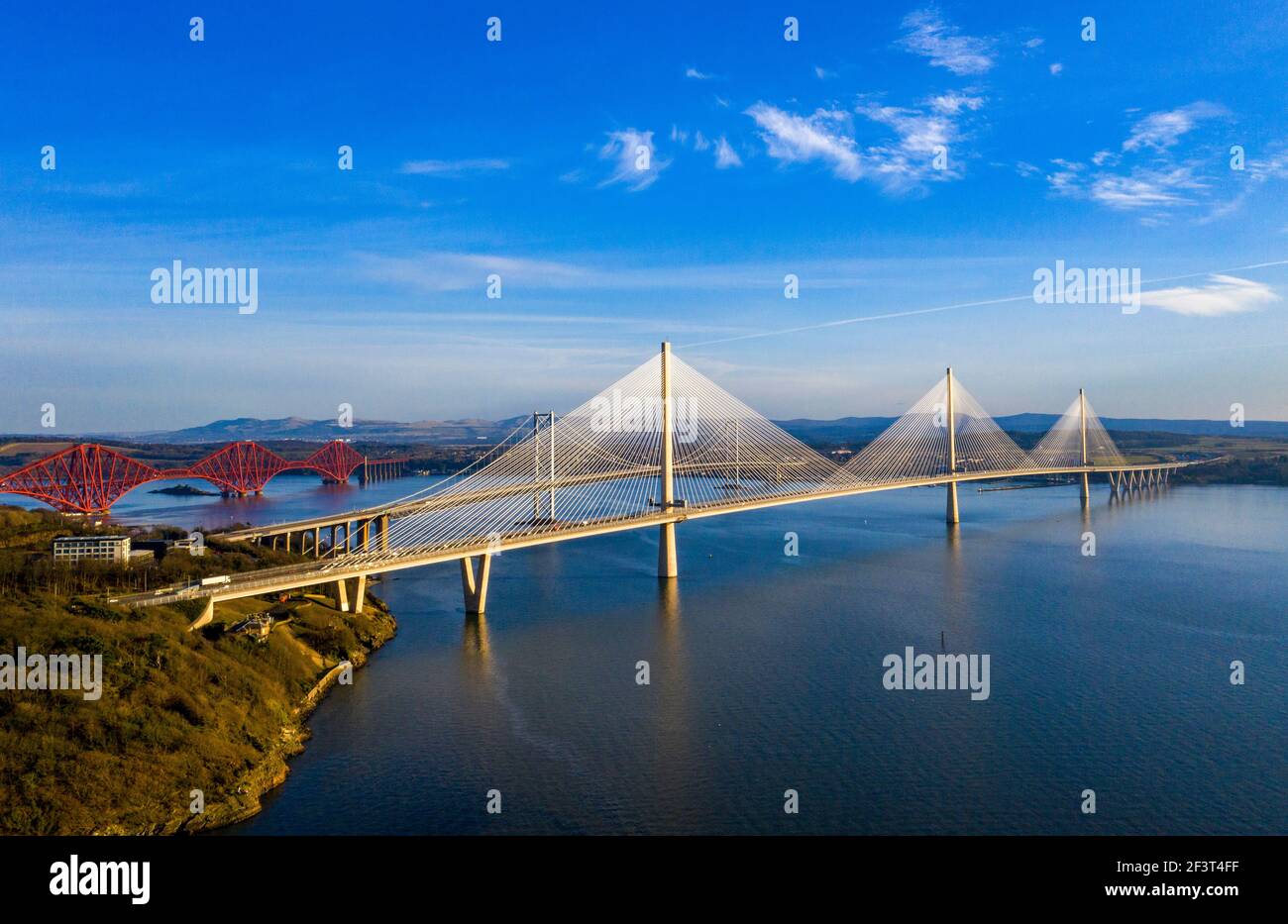 Aerial view from Rosyth showing three bridges spanning the Firth of Forth. The Queensferry Crossing, Forth Road Bridge and Forth Rail Bridge. Stock Photo