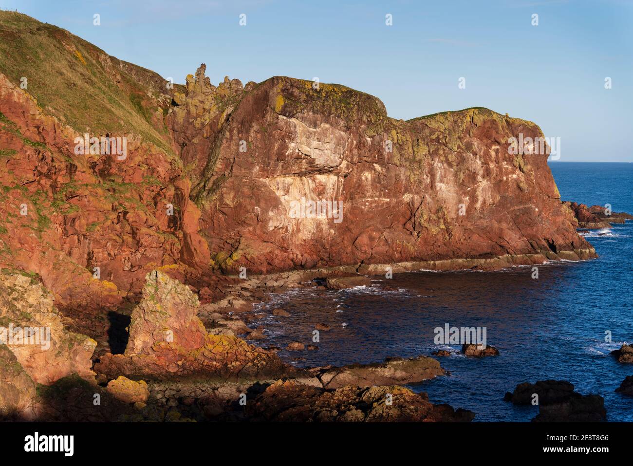 St Abbs, Berwickshire, Scotland - North Sea fishing village and nature reserve. Sandstone red rock cliffs. Stock Photo
