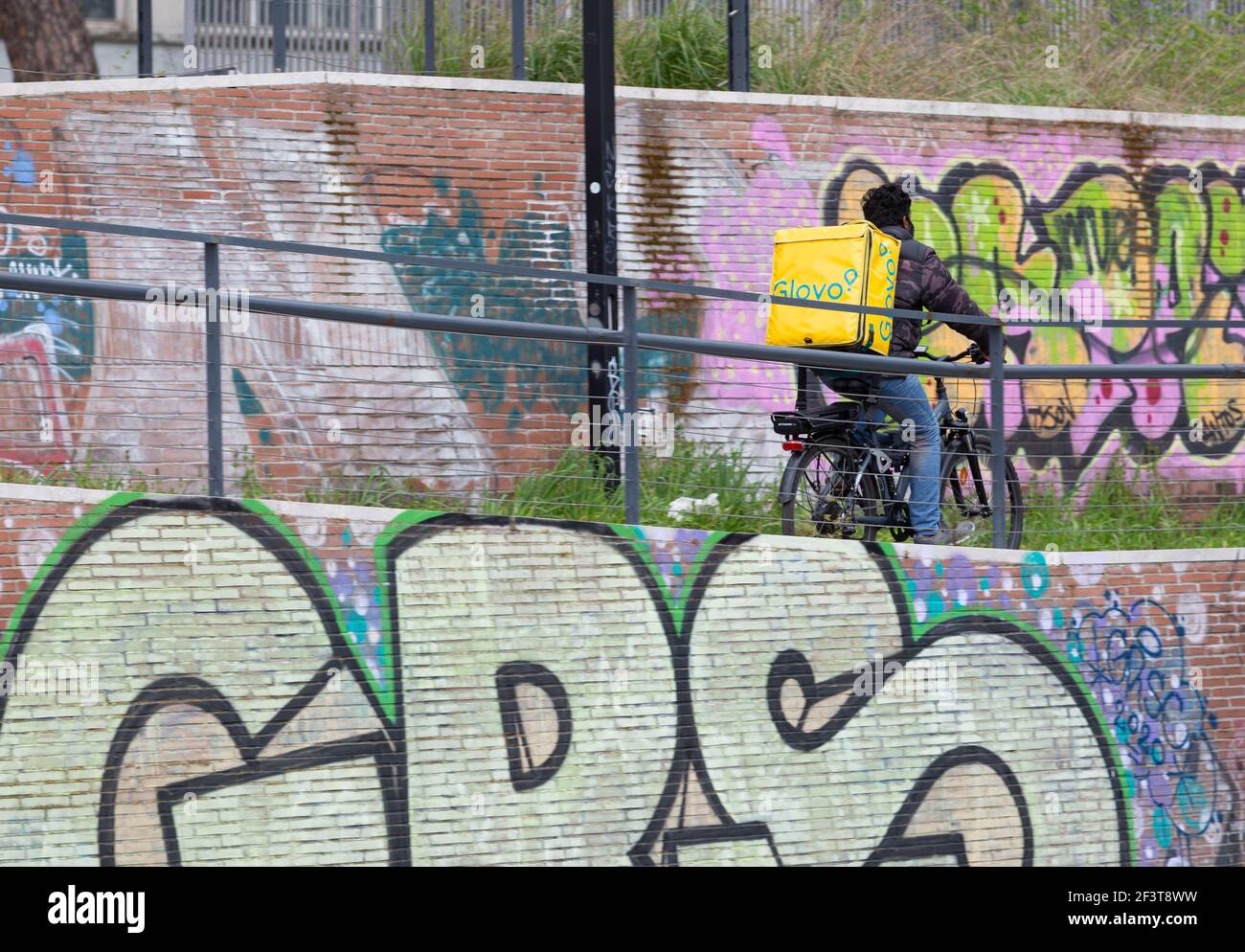 Food delivery rider on electric bicycle Stock Photo - Alamy