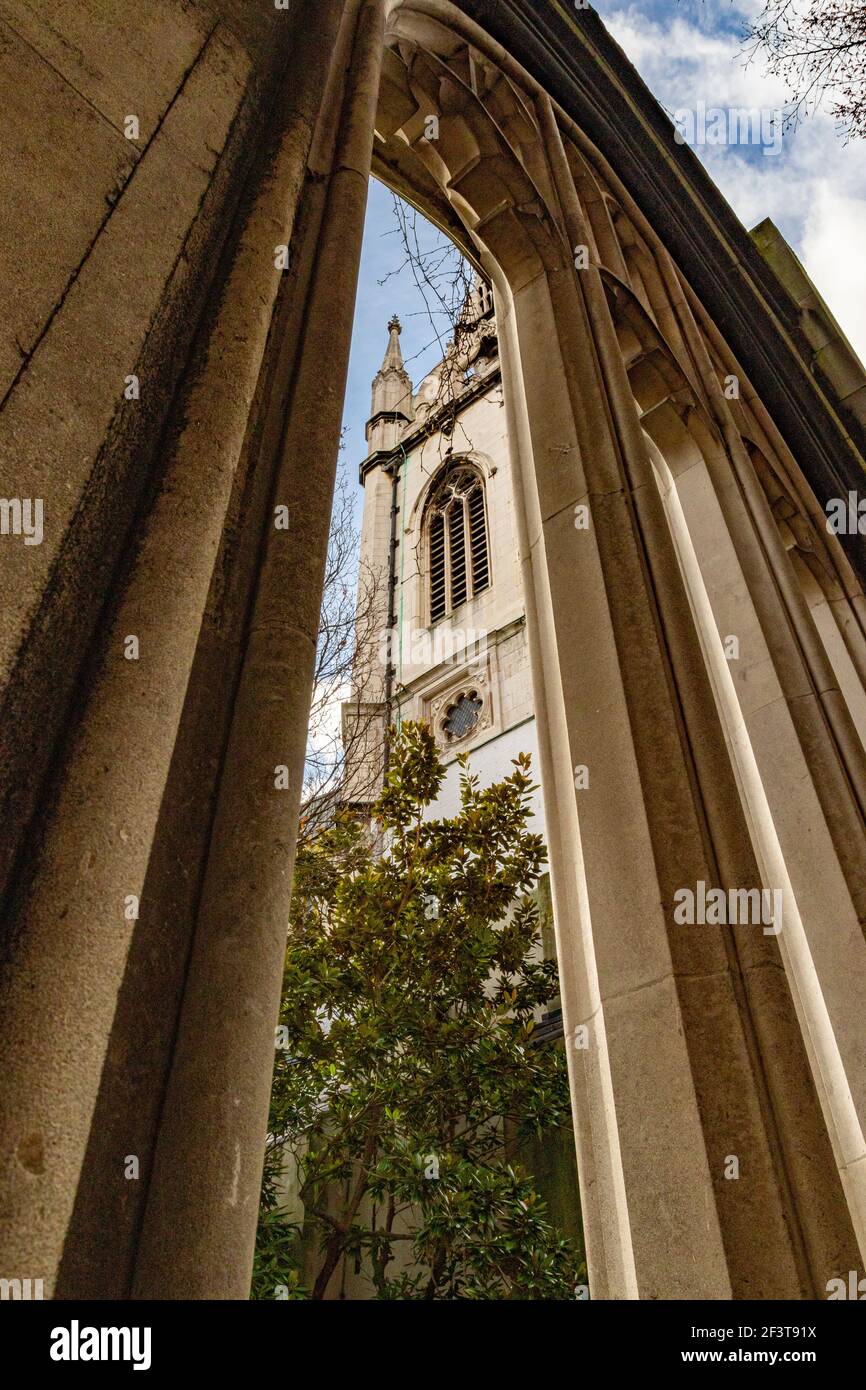 The tower of St Dunstan in the East seen through the remains of a gothic arched window - Stock Image