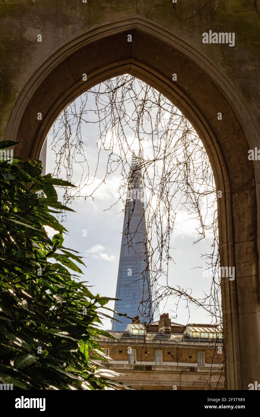 The Shard framed within a gothic arch of St Dunstan in the East - Stock Image