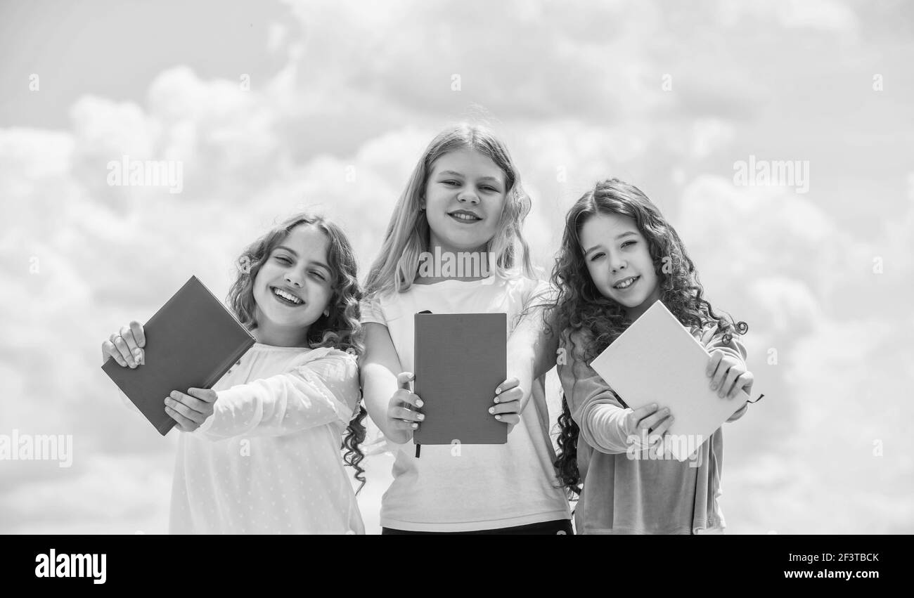 kids reading books. three girls writing in notebook. back to school. write memories in diary. Education and school concept. School students learning Stock Photo