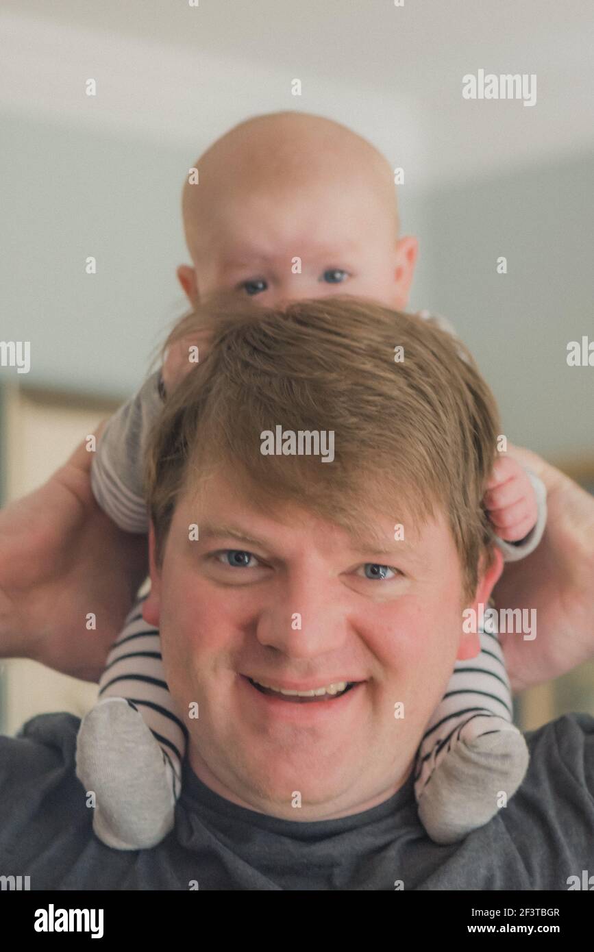 Father with baby on shoulders Stock Photo