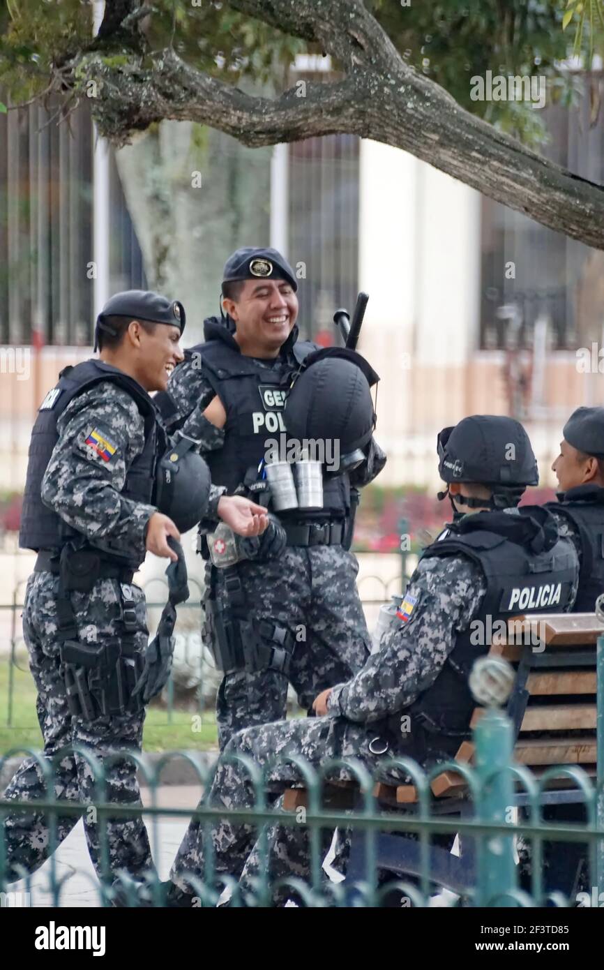 Police officer in riot gear sitting on a park bench at Inti Raymi, the ...