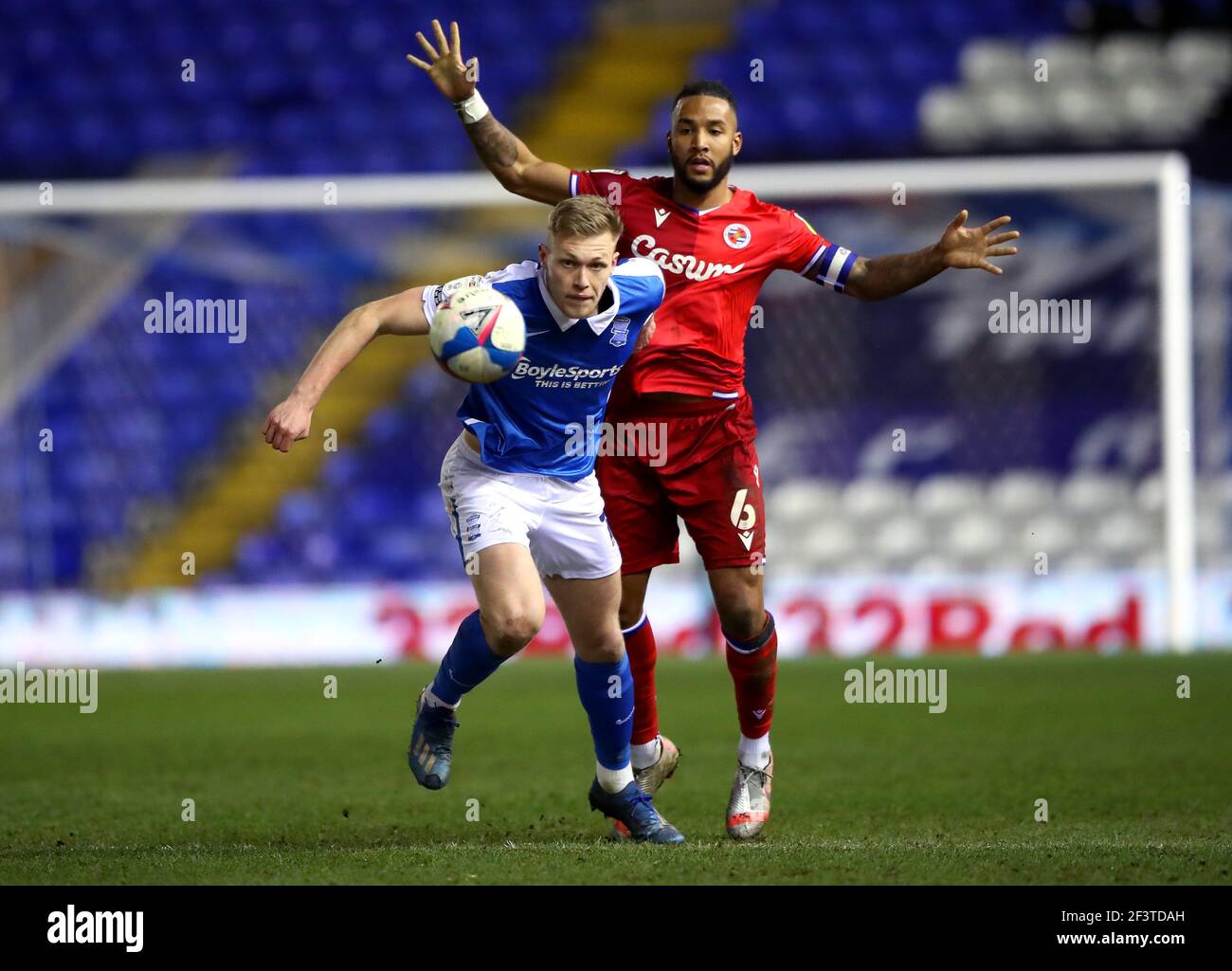 Birmingham City's Sam Cosgrove (left) and Reading's Liam Moore battle for the ball during the Sky Bet Championship match at St Andrew's Trillion Trophy Stadium, Birmingham. Picture date: Wednesday March 17, 2021. Stock Photo