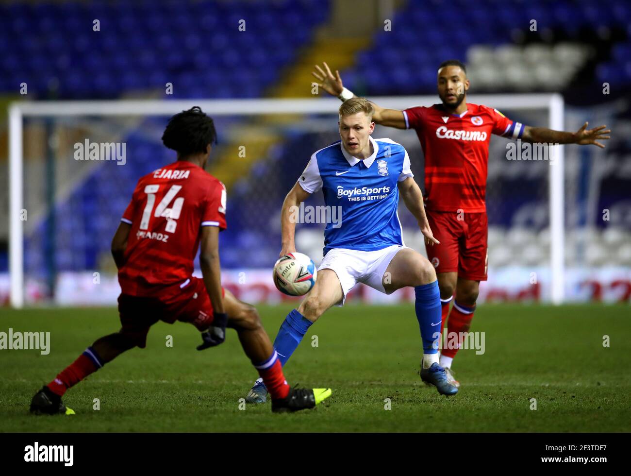 Birmingham City's Sam Cosgrove (centre) battles for the ball with Reading's Liam Moore (right) and Ovie Ejaria during the Sky Bet Championship match at St Andrew's Trillion Trophy Stadium, Birmingham. Picture date: Wednesday March 17, 2021. Stock Photo