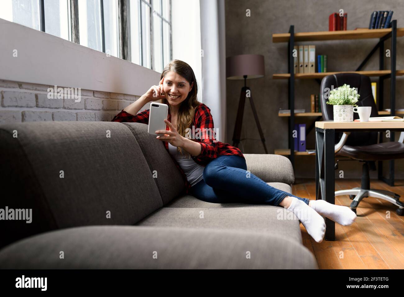 Girl does a video call with her family, due to covid19 coronavirus. Stock Photo
