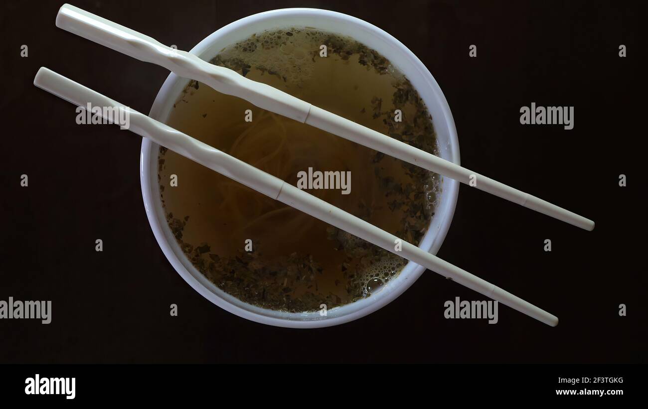 Close up of instant noodles yellow ramen and  Chinese chopsticks Stock Photo