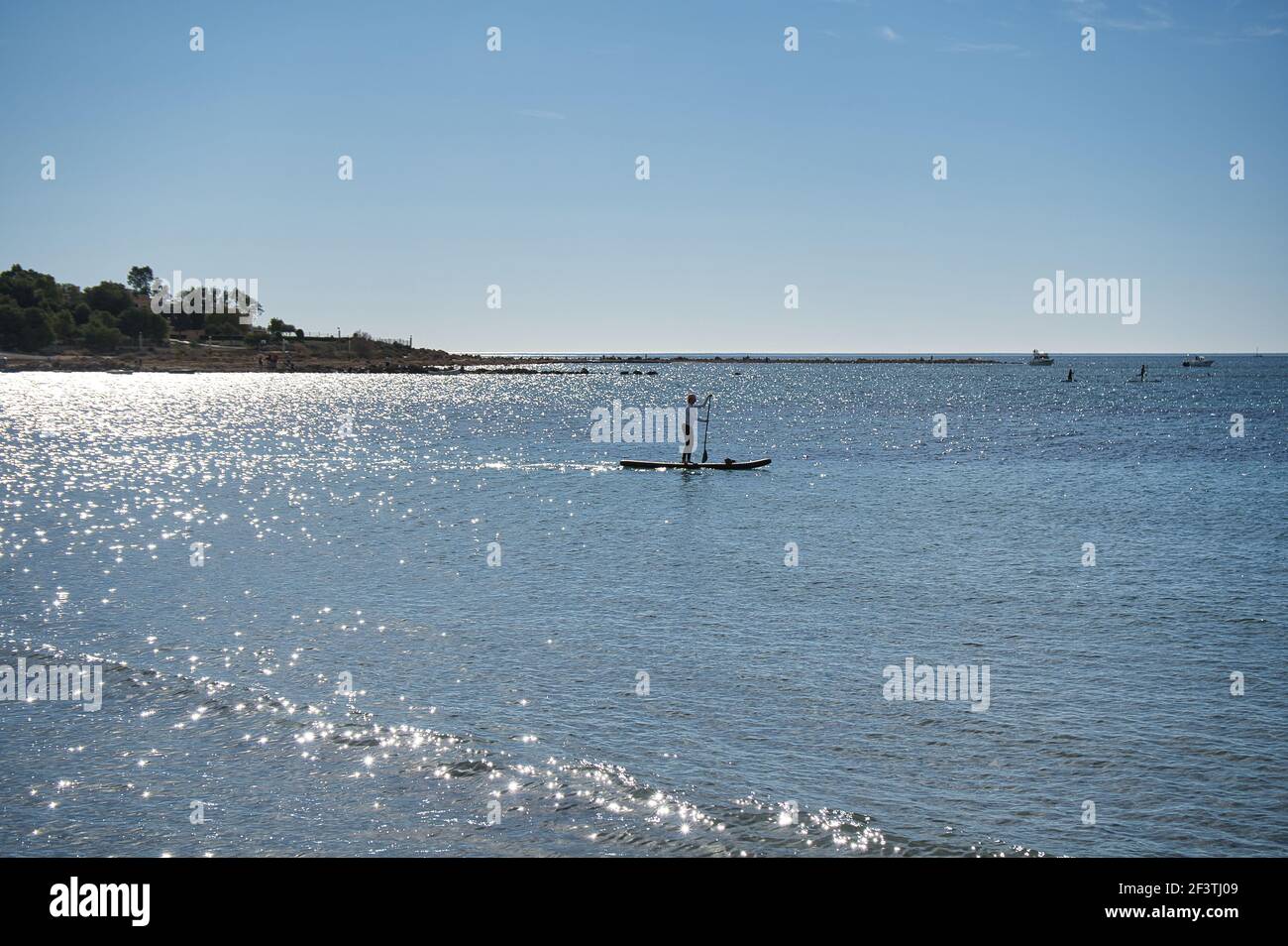 paddle surfing on the beach, located in Alicante, Spain. View Stock