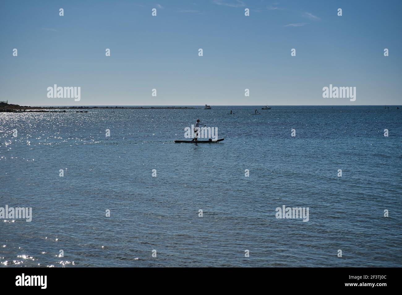 paddle surfing on the beach, located in Alicante, Spain. View Stock