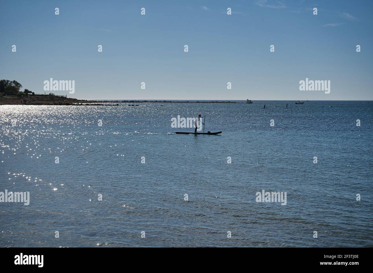 paddle surfing on the beach, located in Alicante, Spain. View Stock