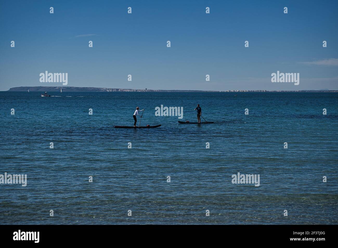 paddle surfing on the beach, located in Alicante, Spain. View Stock