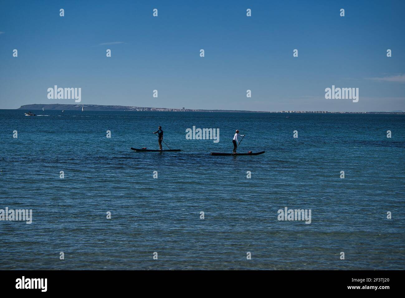 paddle surfing on the beach, located in Alicante, Spain. View Stock