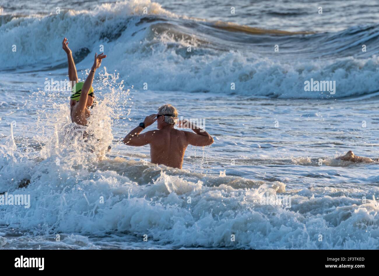 Seniors embarking on a swim in the ocean at Jacksonville Beach in Northeast Florida. (USA) Stock Photo