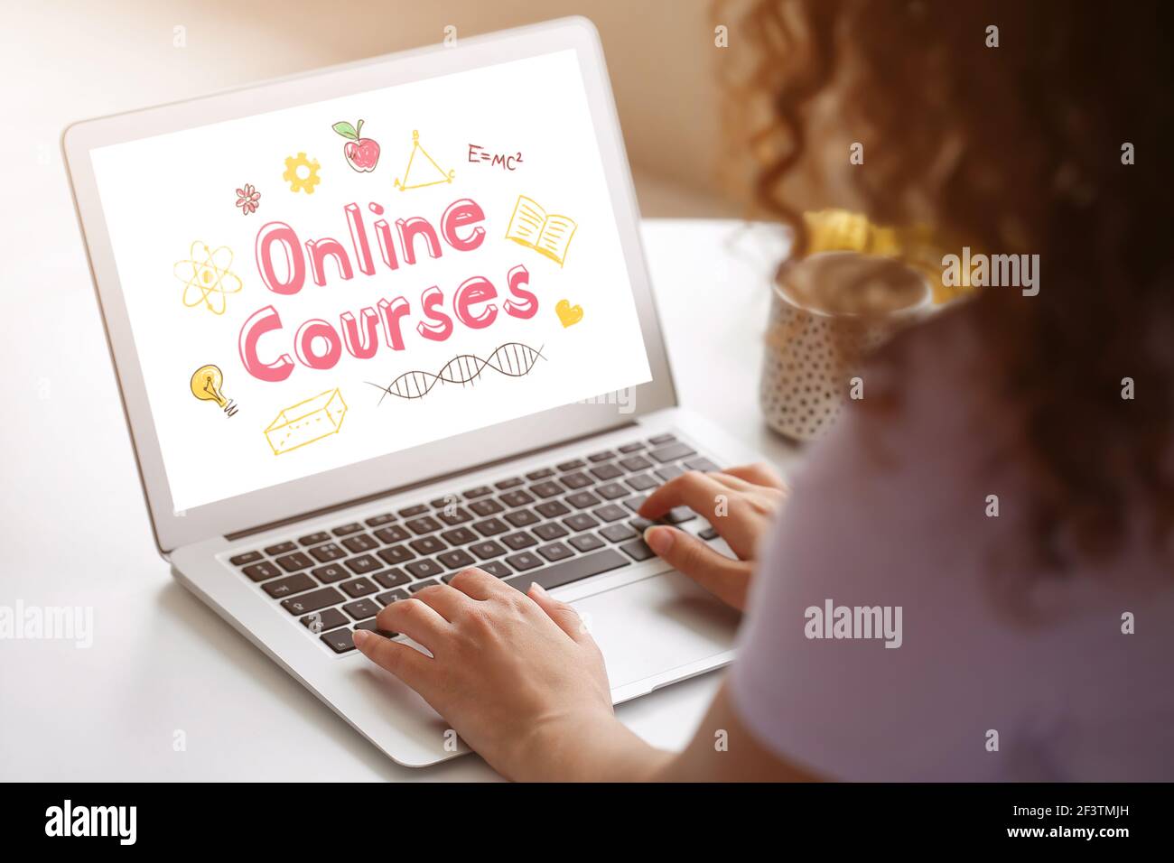 Young woman using laptop for online learning at home Stock Photo