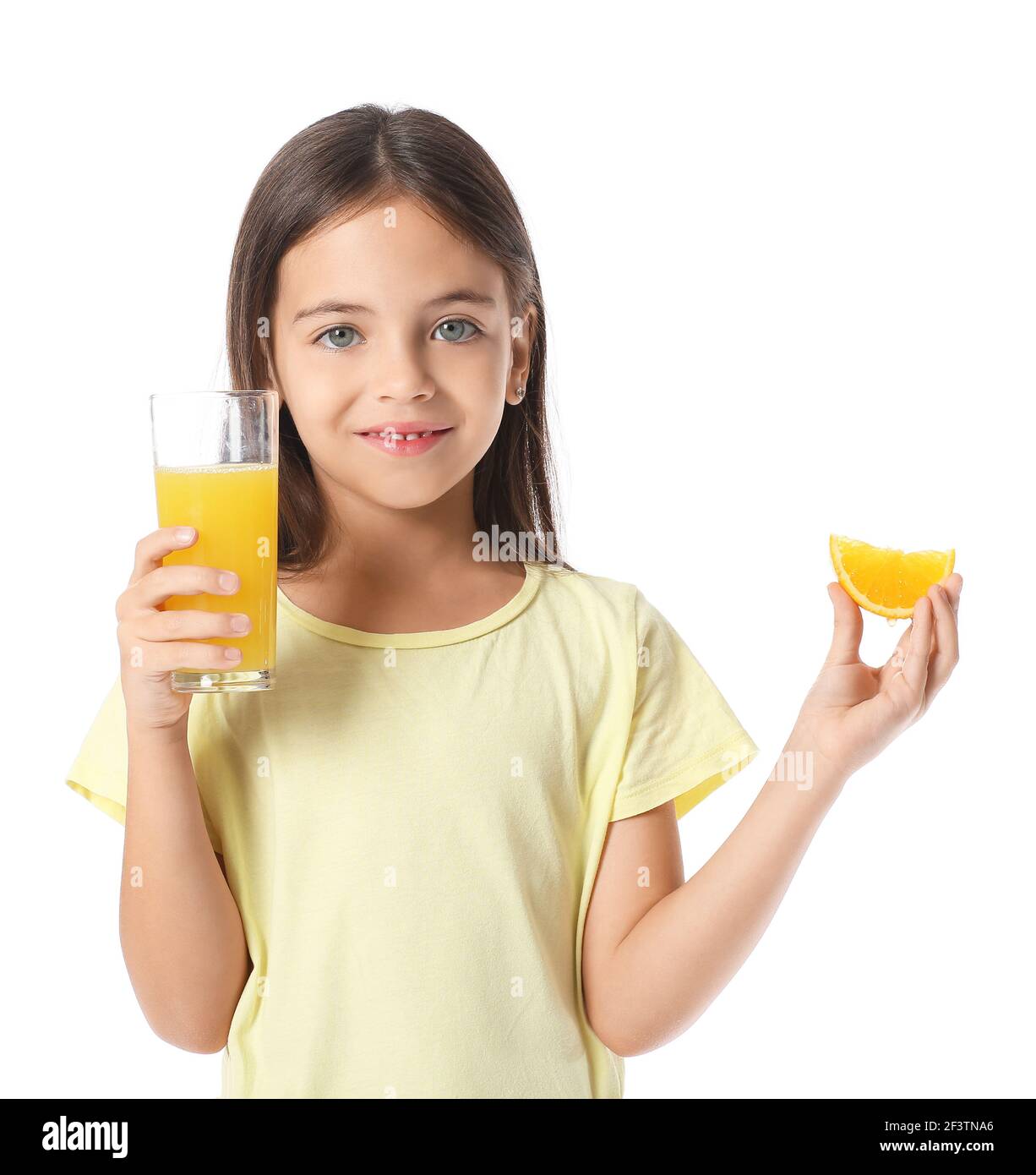 Cute little girl with orange juice on white background Stock Photo - Alamy