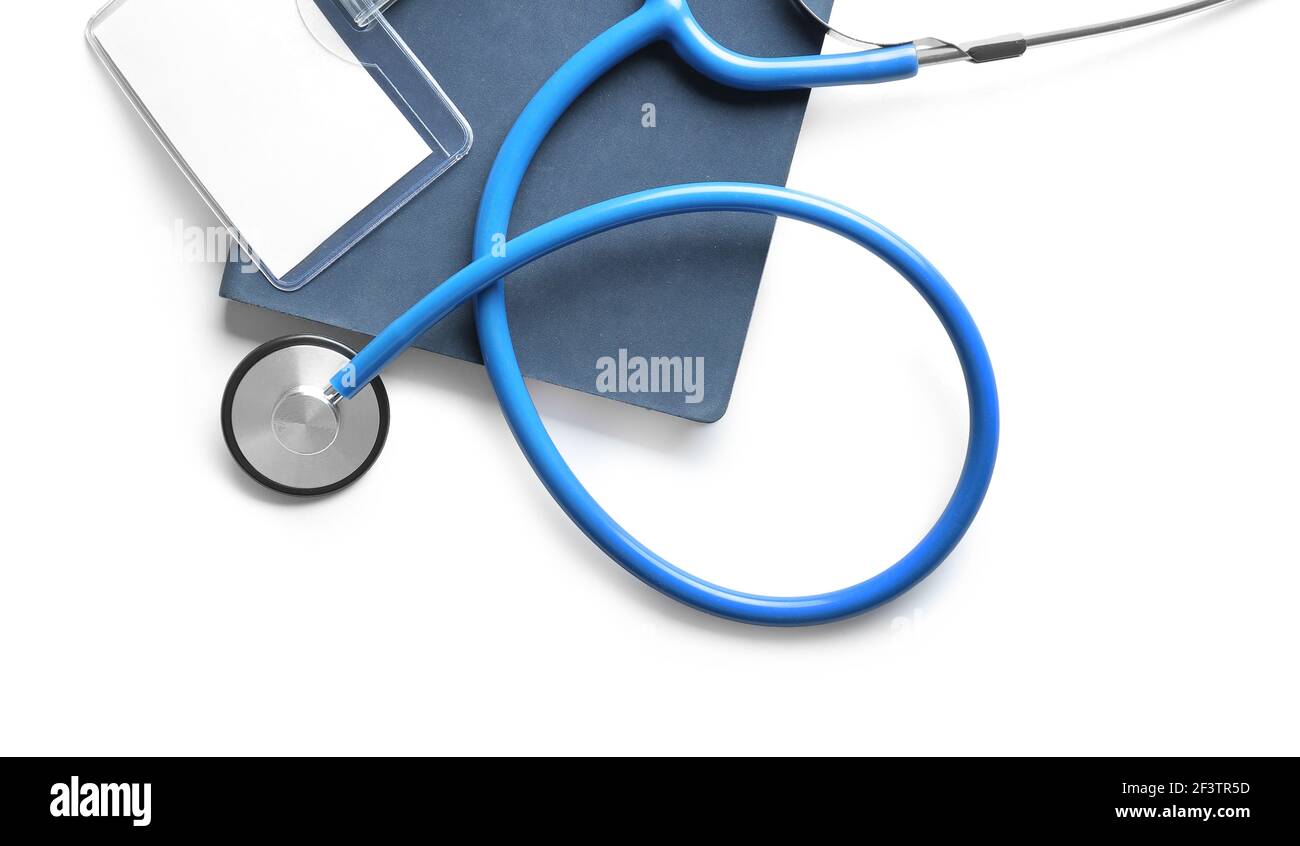Stethoscope, notebook and blank badge on white background Stock Photo ...