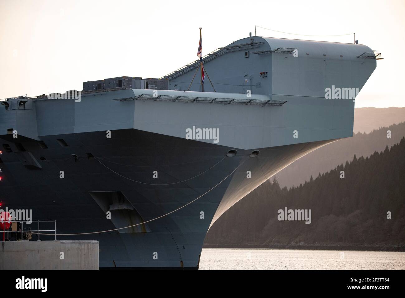 Finnart, Loch Long, Scotland, UK. 17 March 2021. The ramp of HMS Queen Elizabeth. HMS Queen Elizabeth is the largest and most advanced warships ever built for the Royal Navy. Both HMS Queen Elizabeth (pictured) and HMS Prince of Wales are the nation's flagships which weigh in a 65,000 tonnes and measure 280 meters in length. The Aircraft Carrier is currently berthed on the side of Long Loch at Glen Mallan taking on fuel, munitions and other supplies, ahead of naval exercises which are part of the UK Carrier Strike Group 2021. The ship is due to leave on Sunday. Credit: Colin Fisher Stock Photo