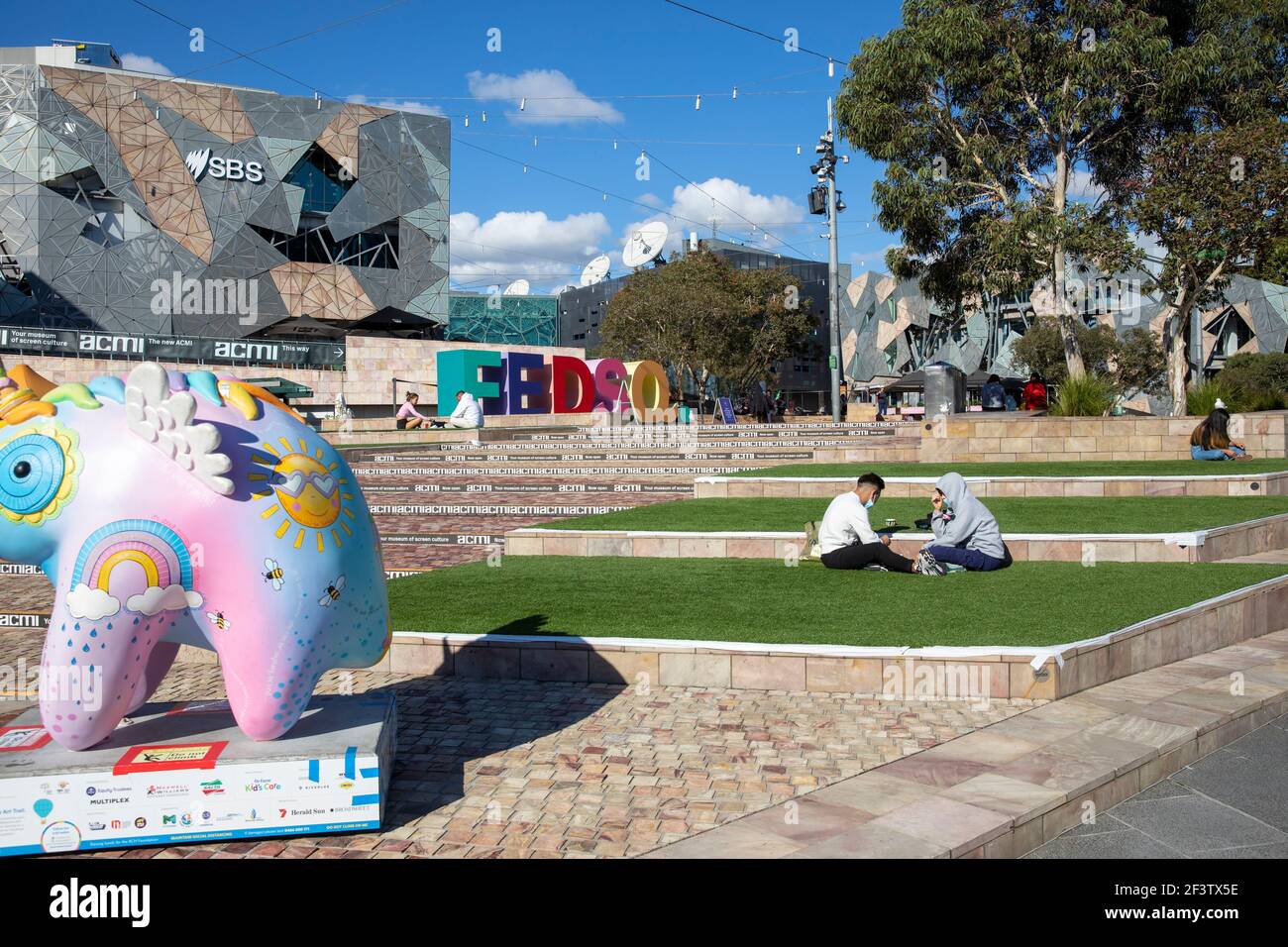 Melbourne Federation square city centre on a sunny autumn day with Uoo Uoo art trail sculpture,Melbourne,Victoria,Australia Stock Photo