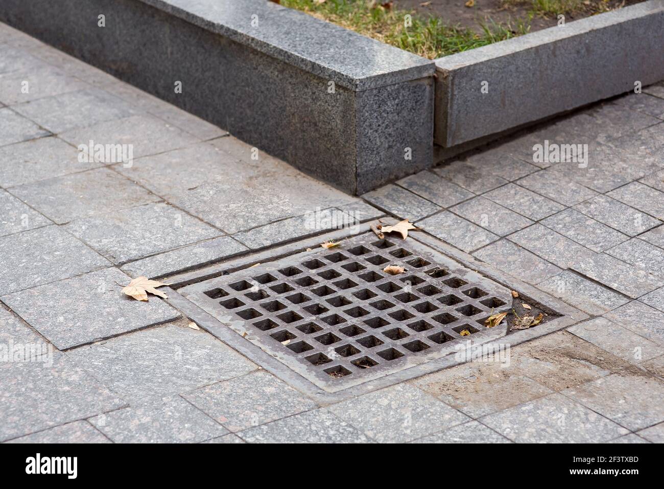 square drainage grate of urban infrastructure pedestrian dirty tile
