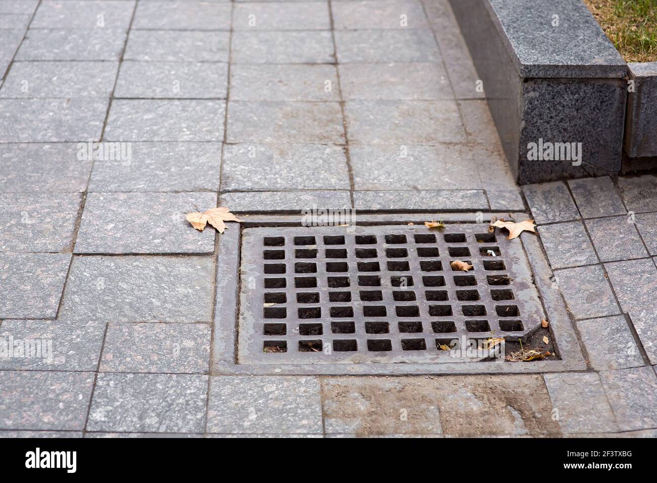 square drainage storm grate systems of city infrastructure pedestrian