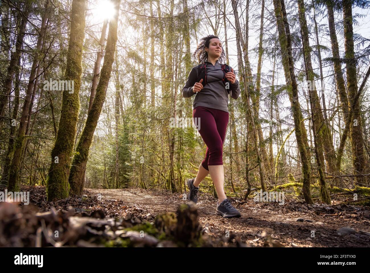 Caucasian Woman Trail Running in the Green Forest Stock Photo - Alamy