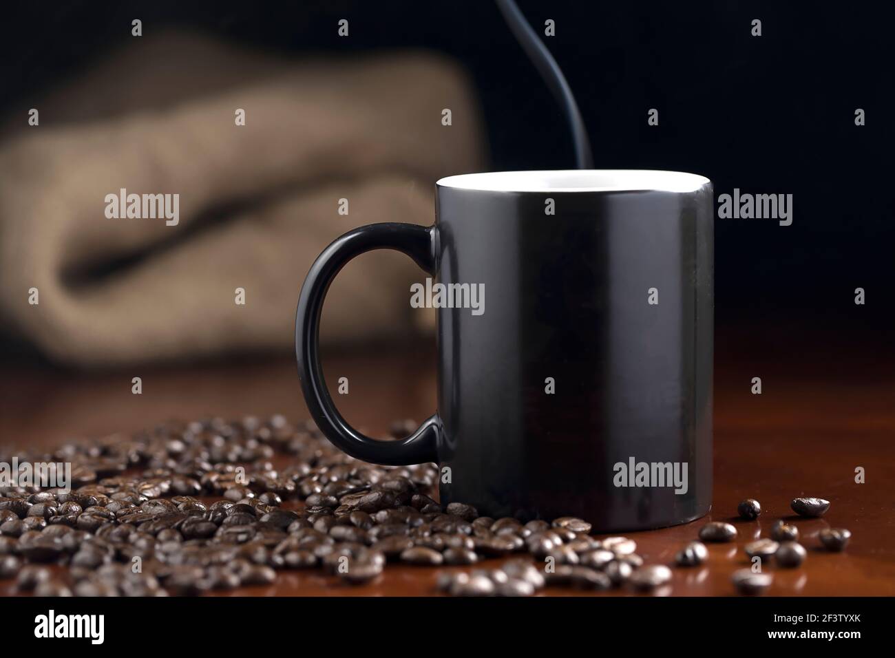A studio photo of steaming coffee in a cup and coffee beans Stock Photo ...