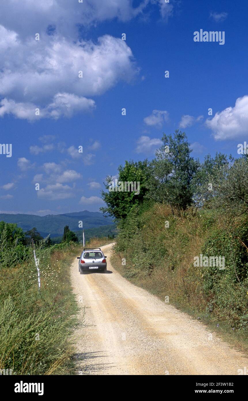 Car touring Tuscany in Italy on dirt road. Stock Photo