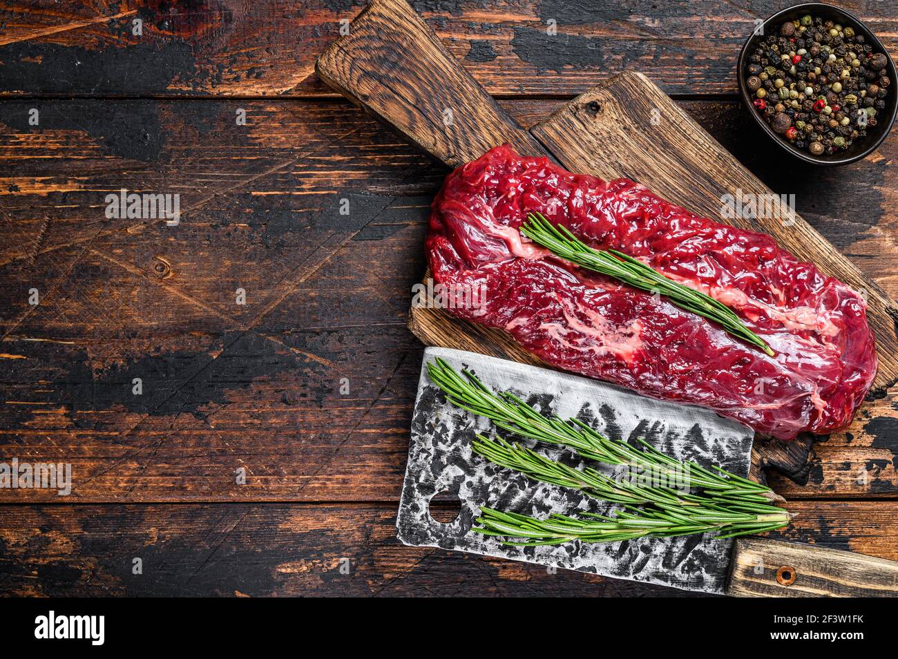Butchers choice raw steak Onglet Hanging Tender beef meat on a cutting board. Dark wooden background. Top view. Copy space Stock Photo