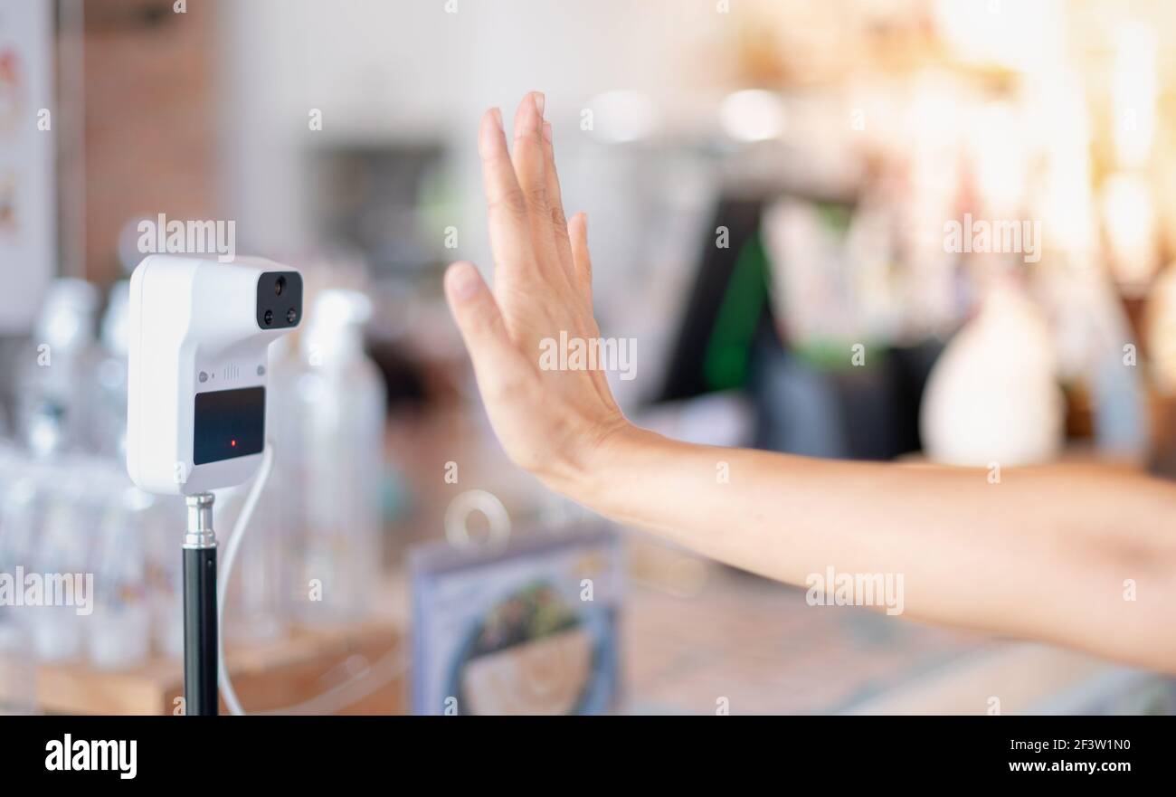 Female hand use digital temperature machine for measuring body