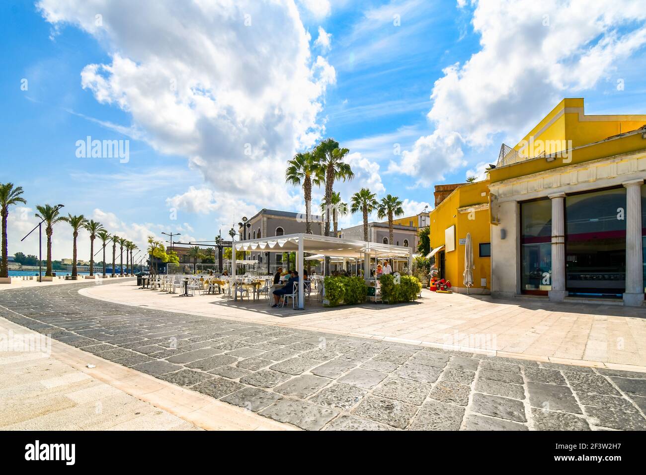 The waterfront harbor and port promenade at the coastal city of Brindisi, Italy, in the Puglia region. Stock Photo