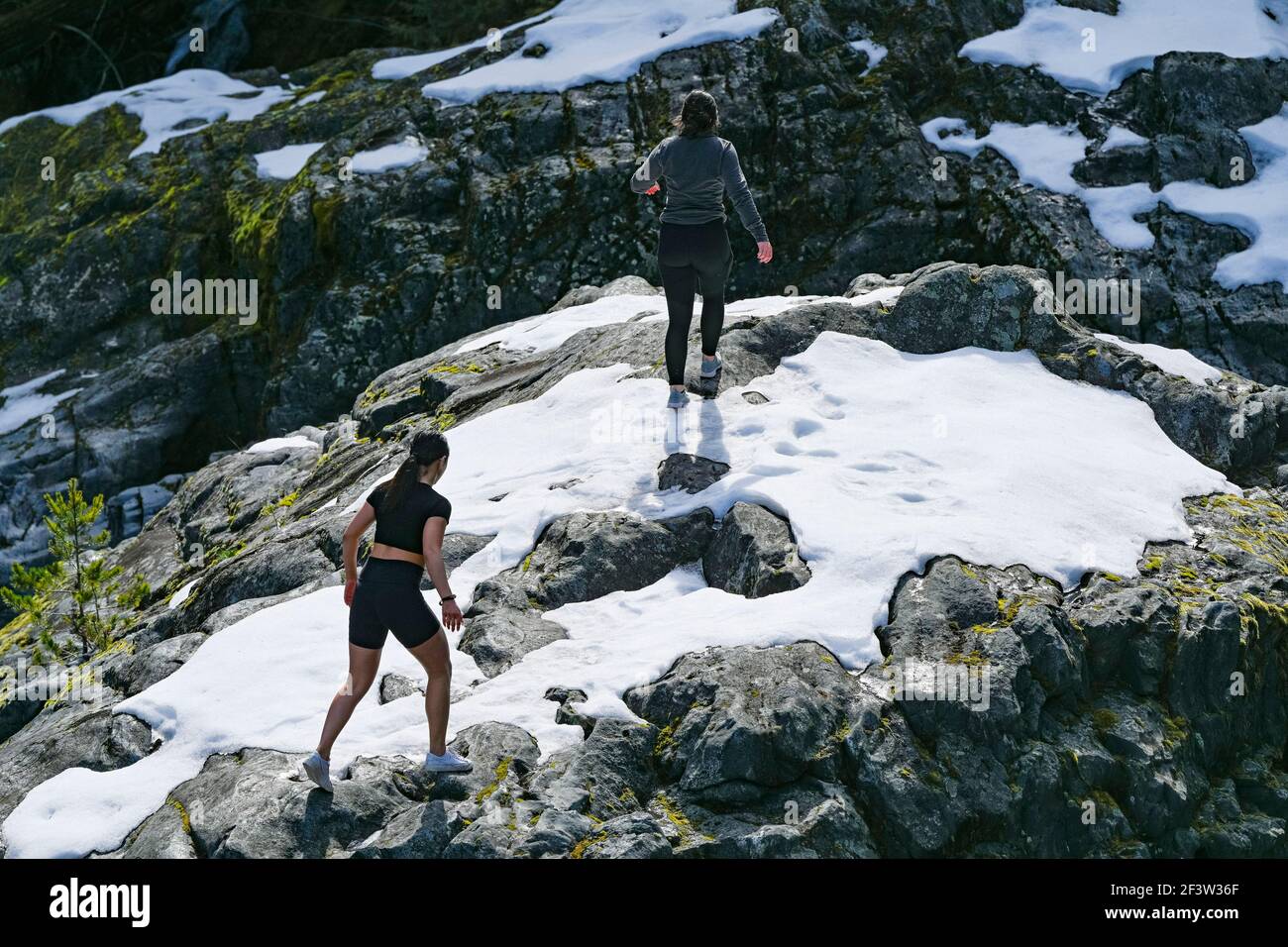 Young women on rocks above Green River, Nairn Falls Provincial Park, Pemberton,British Columbia, Canada Stock Photo
