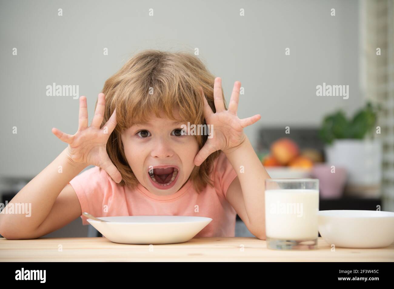 Child eat. Little healthy funny hungry boy eating soup. Stock Photo